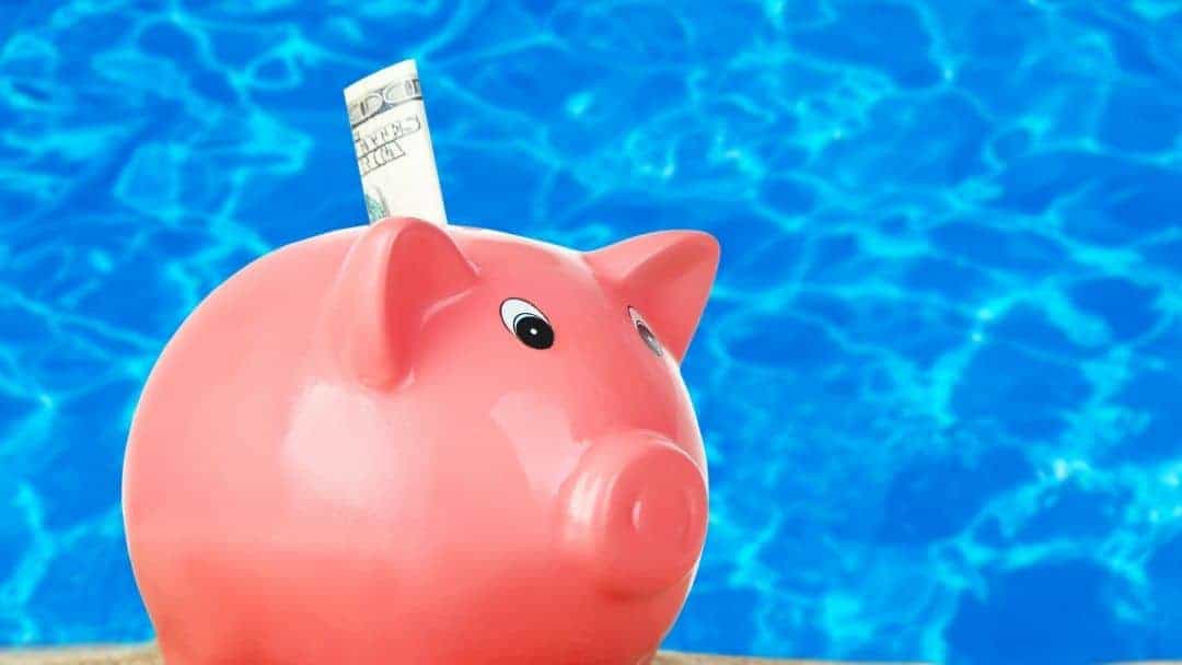 swimming pool financing? Image of a piggy bank in front of blue waters representing the next section on swimming pool financing.