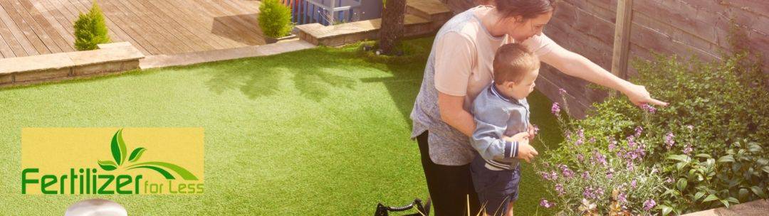 A mother and child working in a backyard garden.