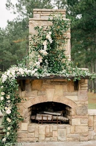 An outdoor wedding venue called 'the hearth' themed in greenery.